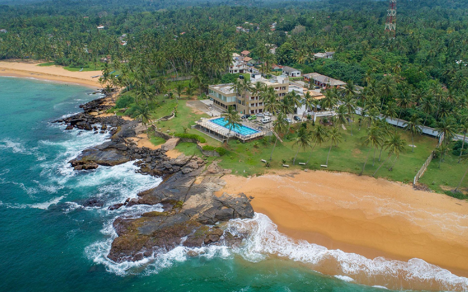 Aerial view of a hotel and coastline in Hikkaduwa, Sri Lanka